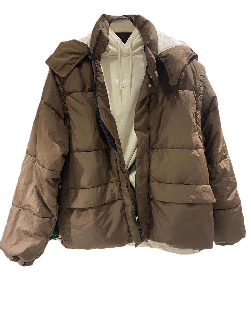 Brown puffer jacket on a mannequin in a clothing store