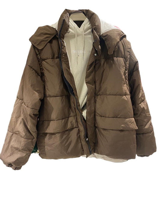 Brown puffer jacket on a mannequin in a clothing store