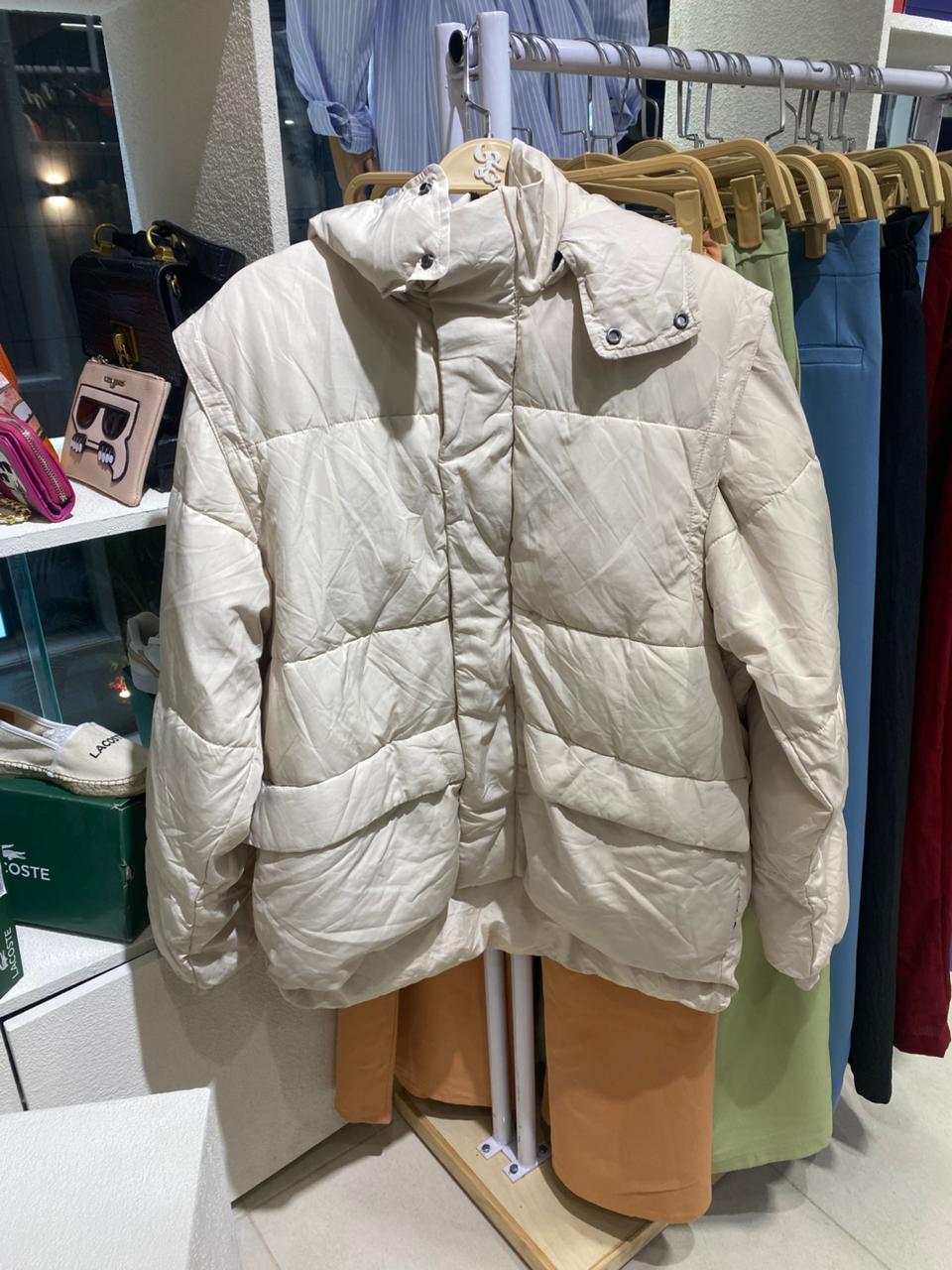 bige puffer jacket on a rack in a store setting